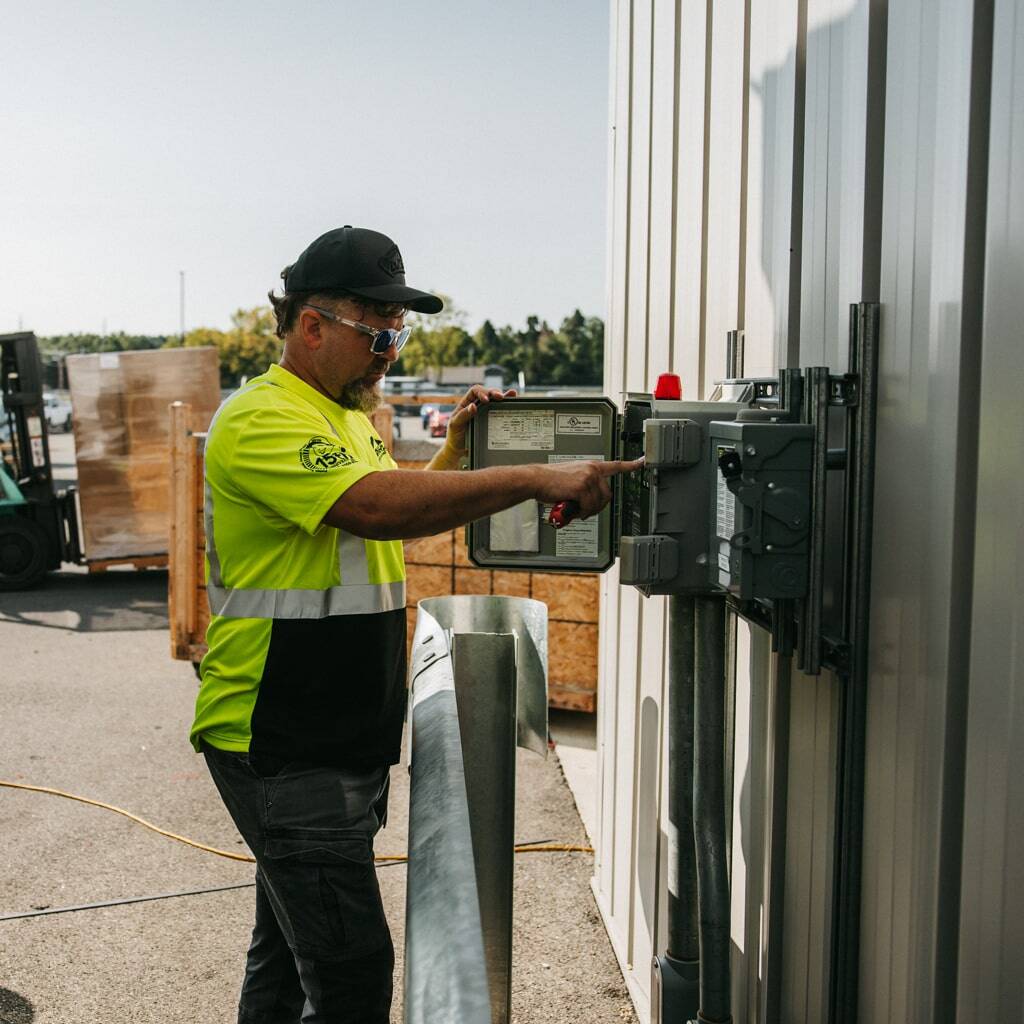 technician servicing septic lift station controls
